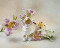 Happy astronaut standing with raised hands surrounded by flowers